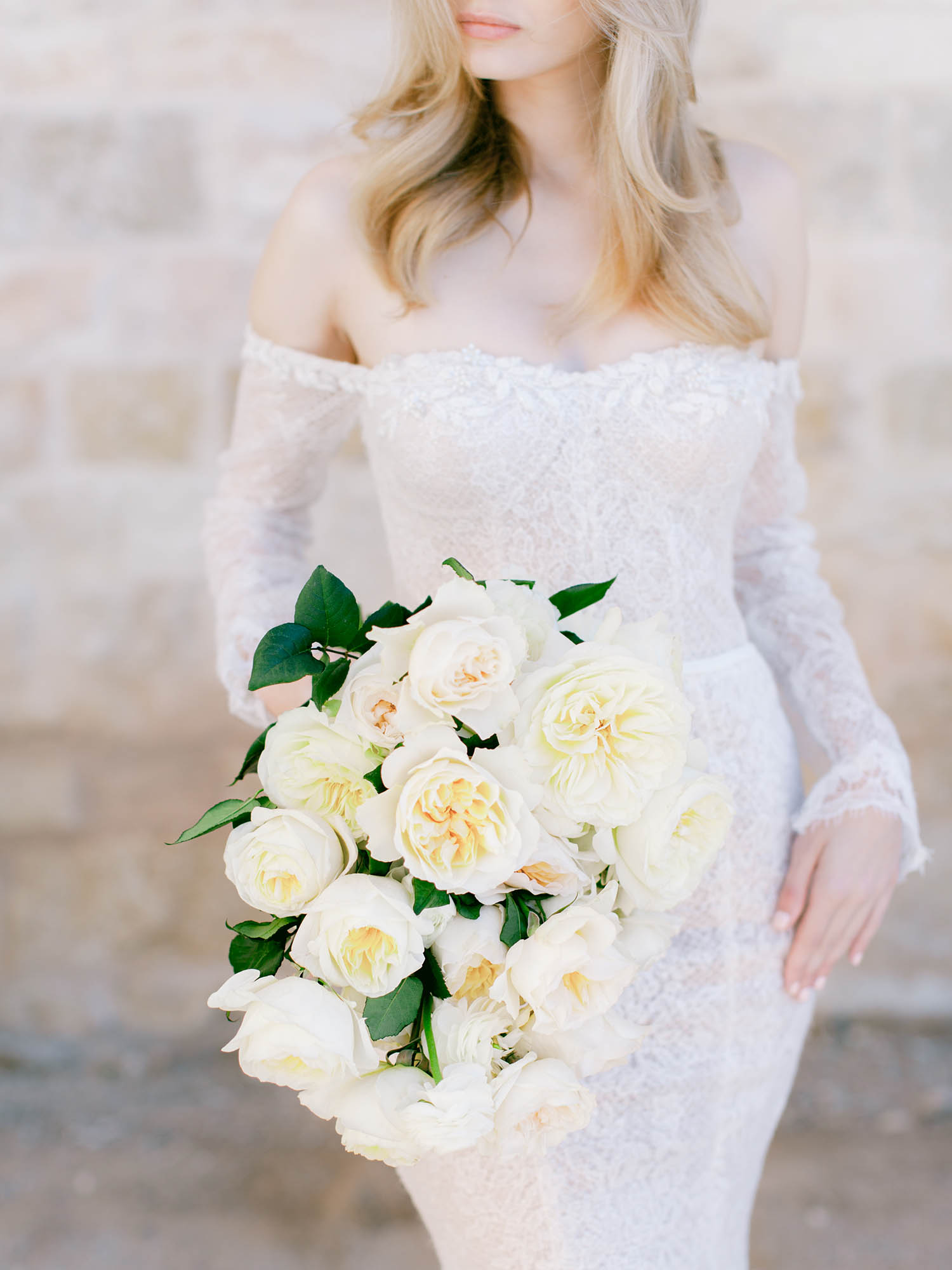 Bride Holding Wedding Bouquet with Roses